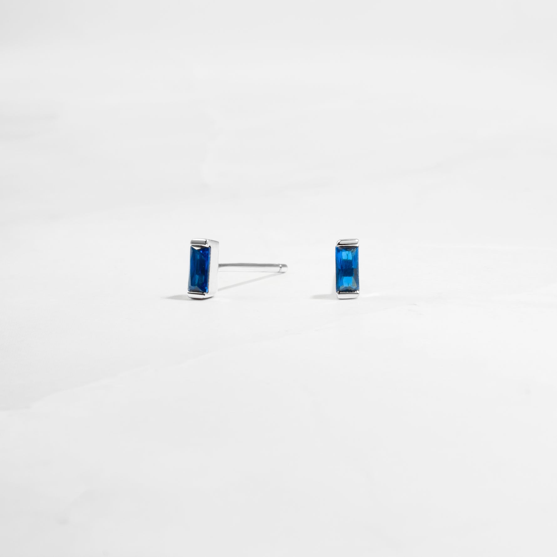 closeup image of minimalist blue earrings