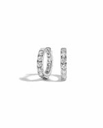 a pair of silver studded hoop earrings