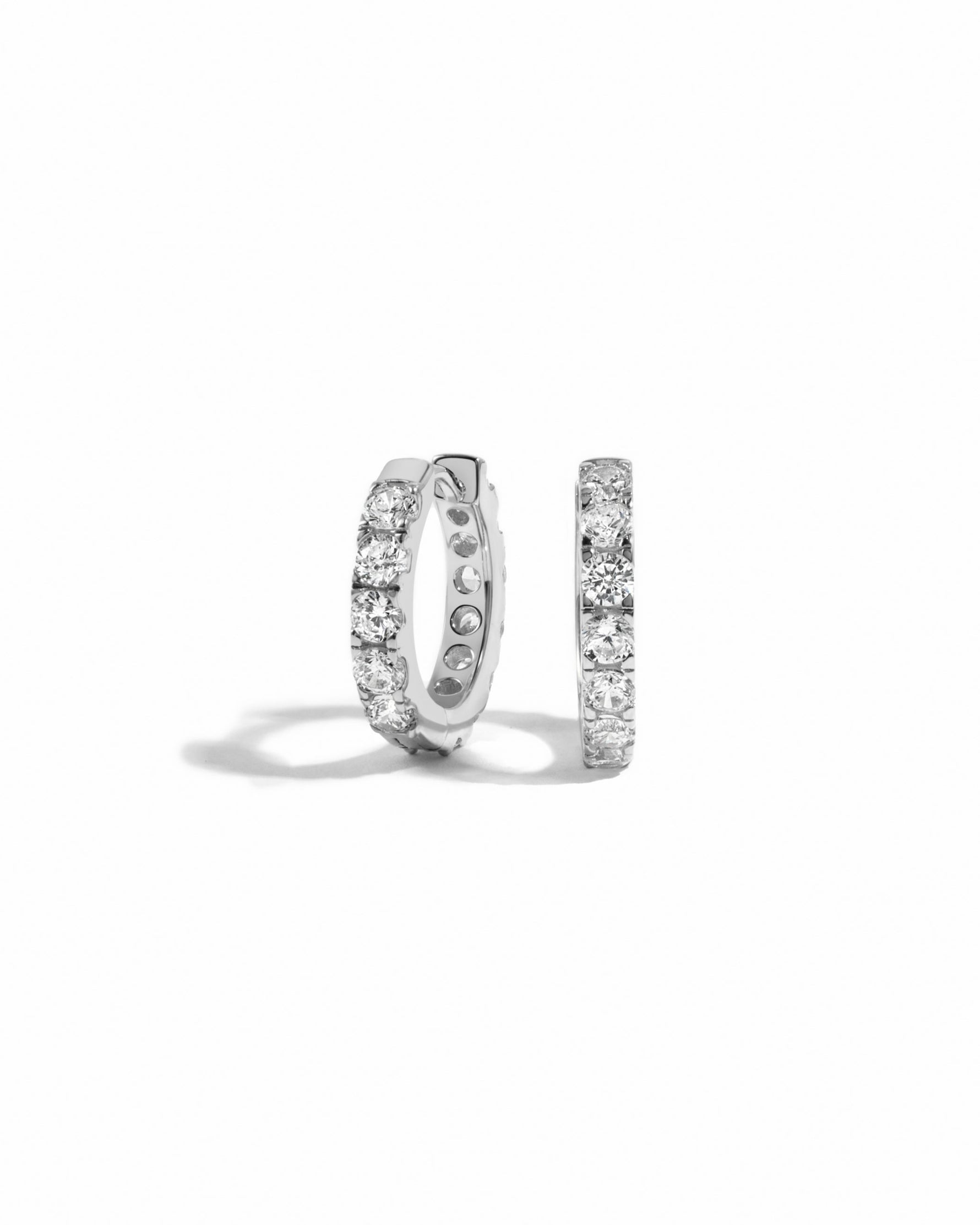 a pair of silver studded hoop earrings