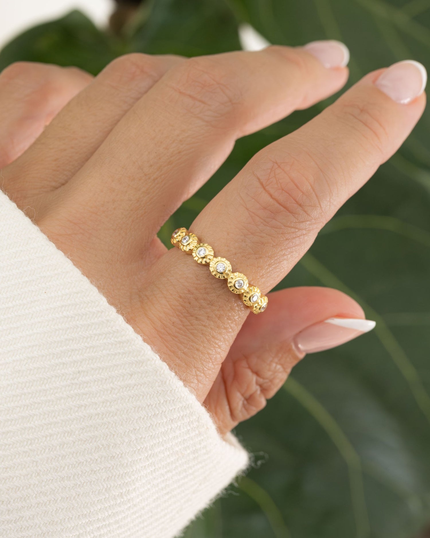Model wearing a gold ring with a vintage ring design