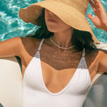 Model relaxing in pool wearing Sami Jewels 14k Gold Plated Necklace Bundle of 3 from Sami Jewels.