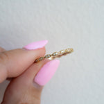 Model showcasing gold eternity band with pave diamonds