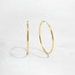 closeup image of dainty thin hoop earrings