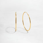 closeup image of dainty thin hoop earrings