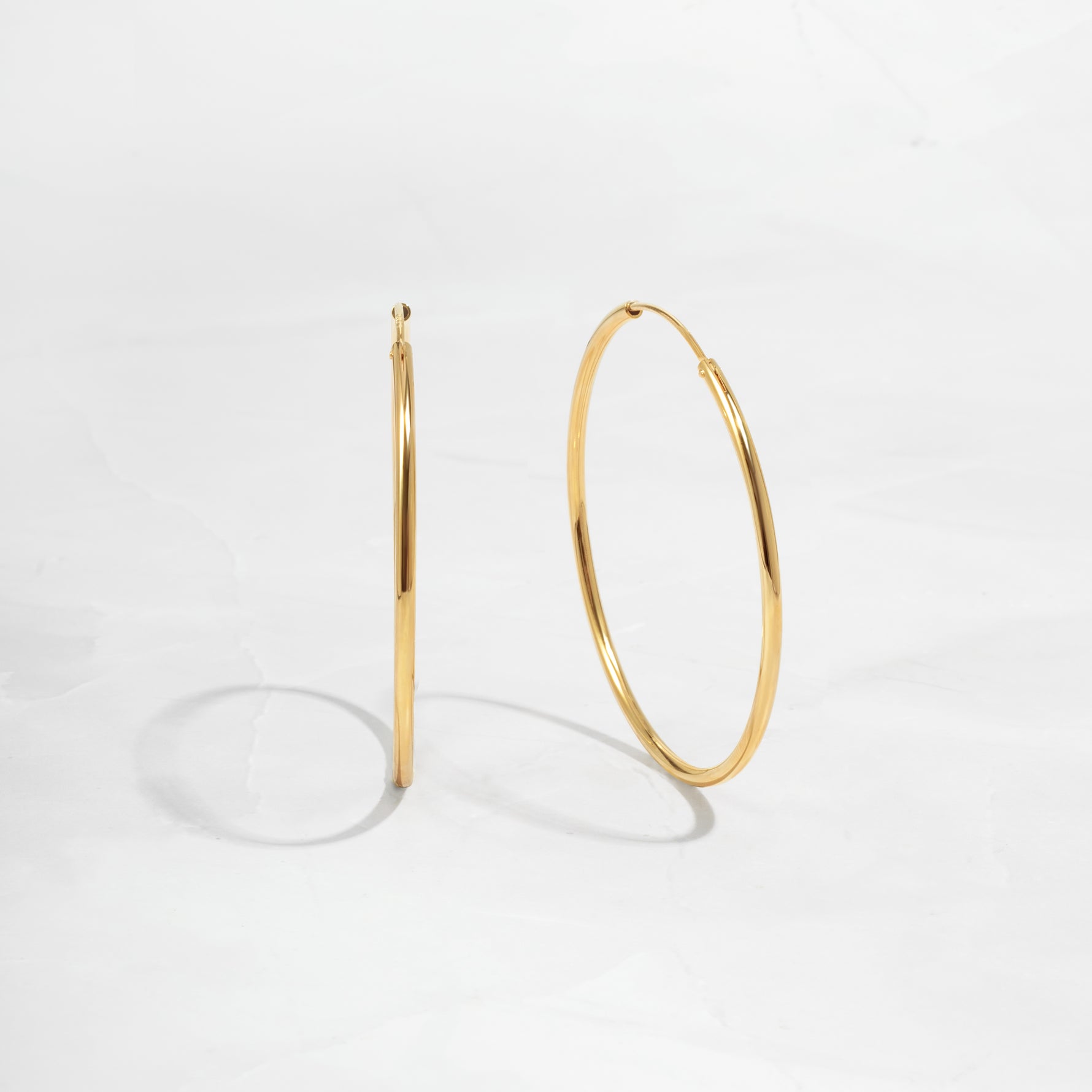 closeup image of dainty thin hoop earrings
