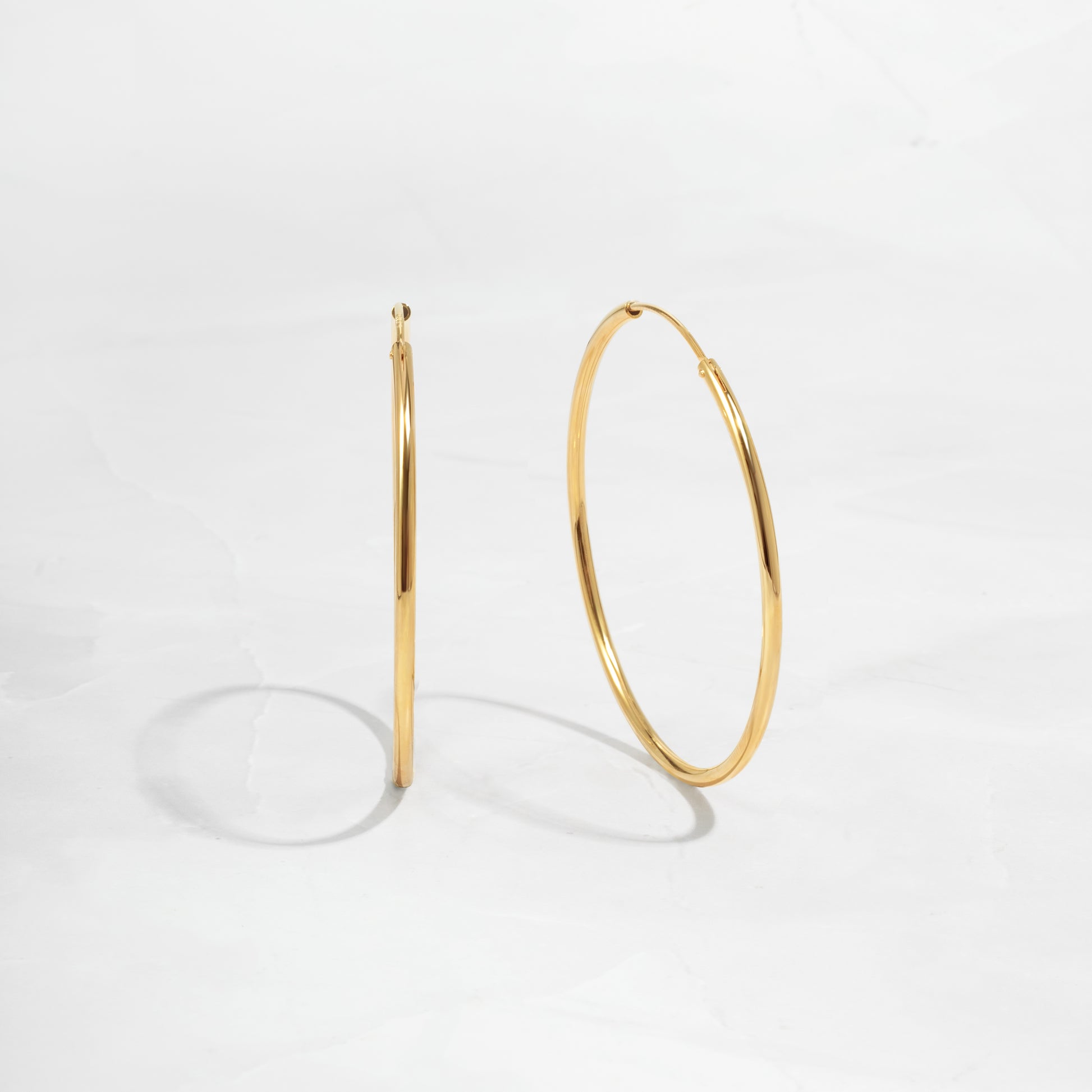 closeup image of dainty thin hoop earrings