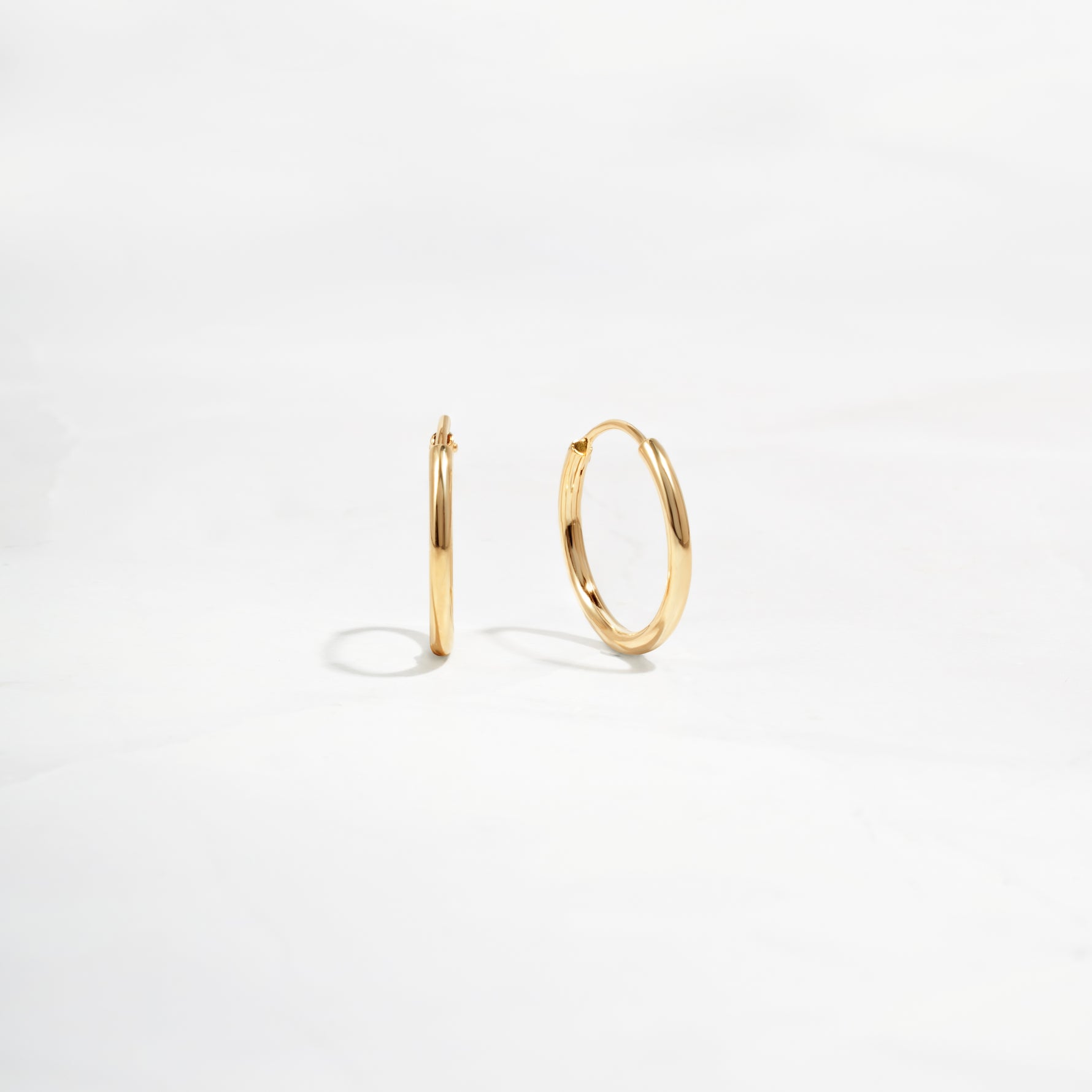 closeup of dainty gold everyday earrings