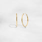 Closeup image of thin dainty hoop earrings