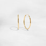 Closeup image of thin dainty hoop earrings