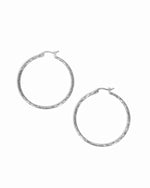 Silver hoop vintage earrings on a white background