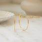 closeup image of skinny gold hoop earrings