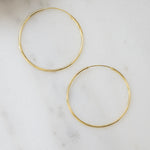 closeup image of gold threader earrings