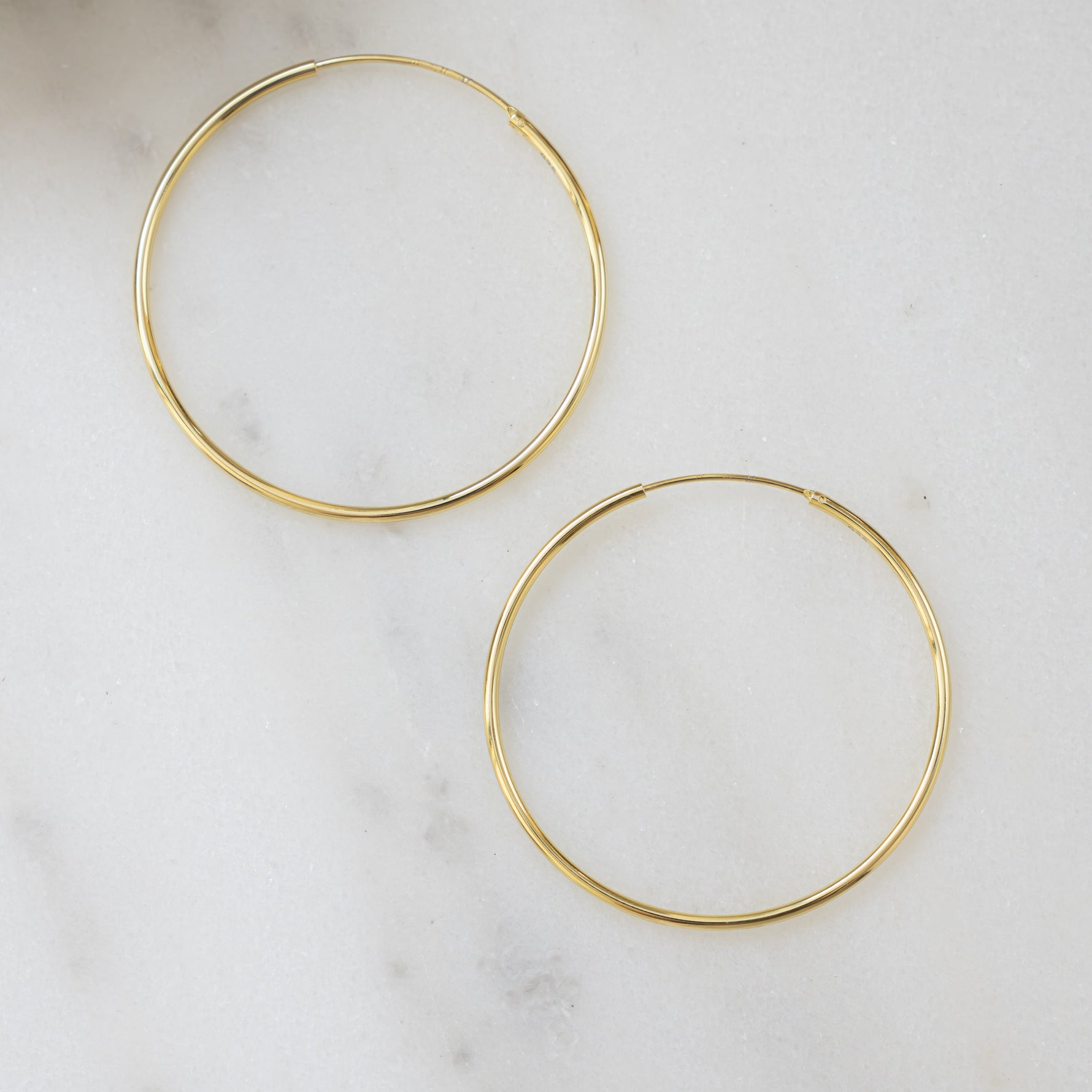 closeup image of gold threader earrings