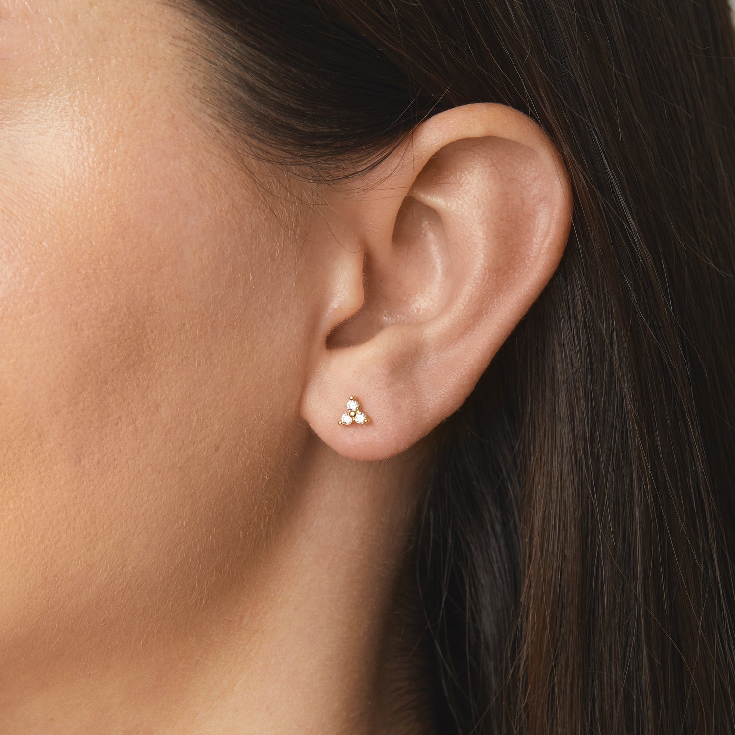 model wearing tiny stud earrings