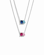 Two sterling silver necklaces with custom birthstone gemstones on a white background