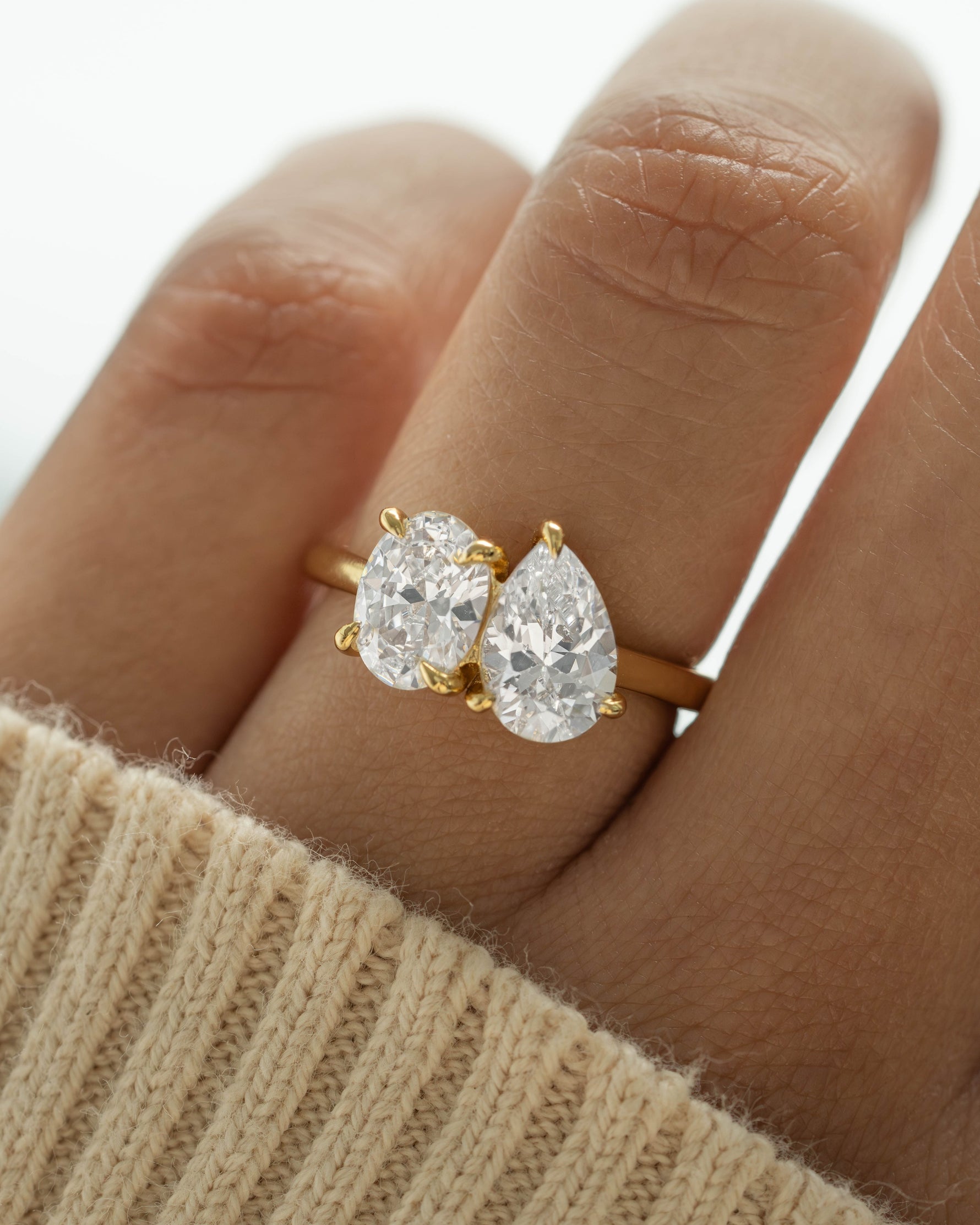 Gold oval engagement ring on model