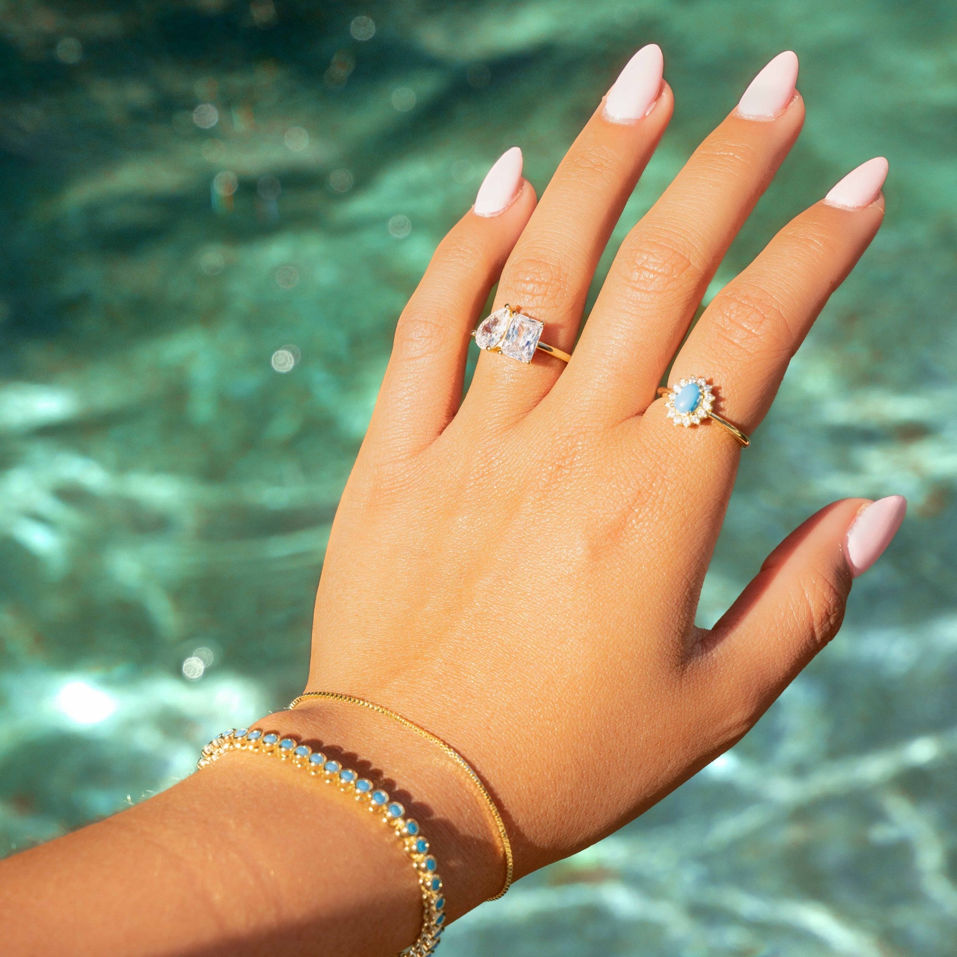 model wearing toi et moi ring paired with turquoise jewelry