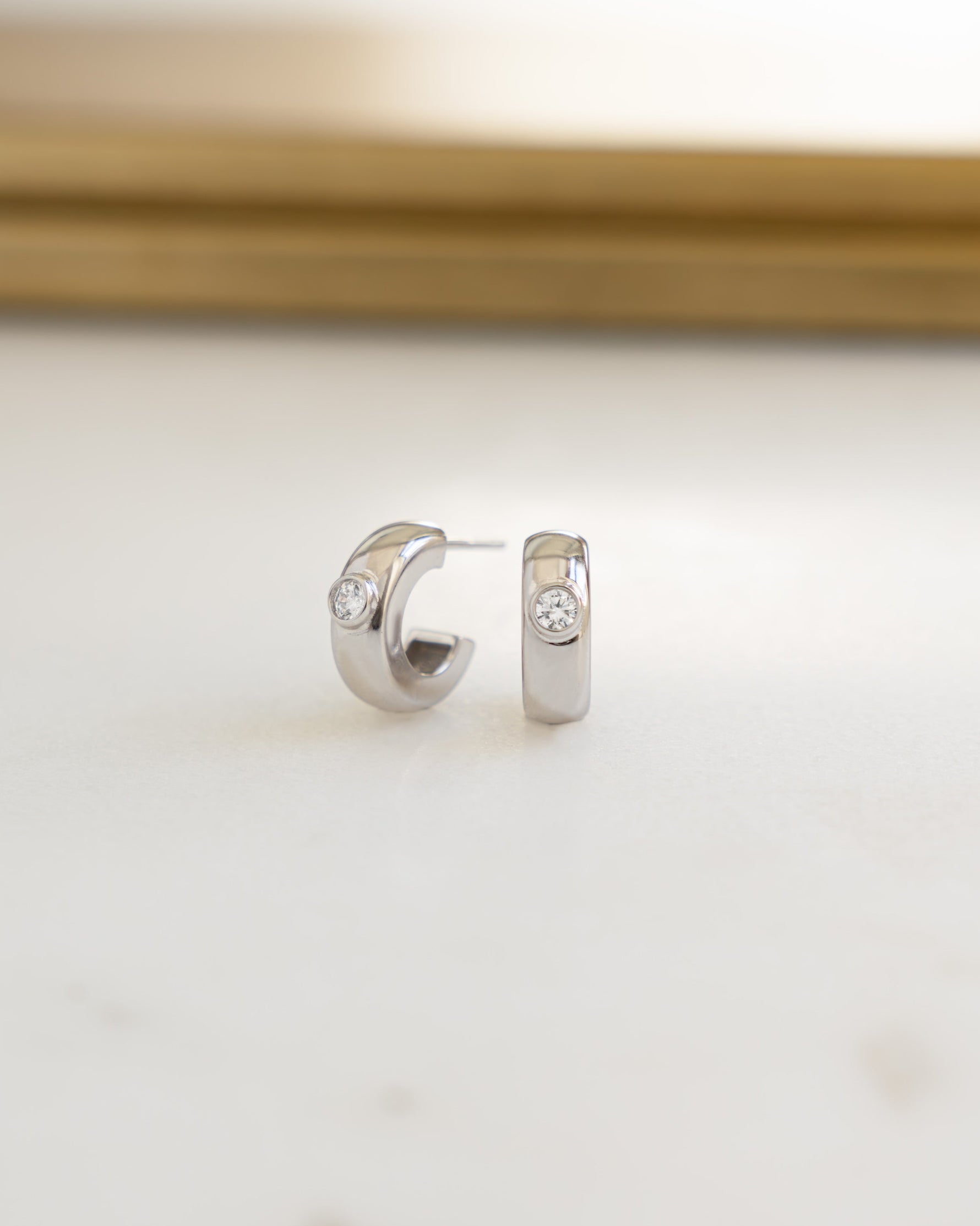 Silver bezeled chunky hoop earrings by Sami Jewels featuring bold, stylish hoop designs for a modern look.