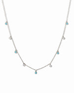 sterling silver necklace with small turquoise and cubic zirconia gemstones on a white background