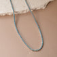 closeup image of turquoise jewelry featuring a dainty silver tennis necklace