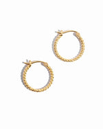 Closeup image of simple gold twist hoop earrings