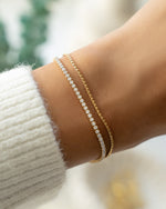 Gold tennis bracelet and chain bracelet set on model