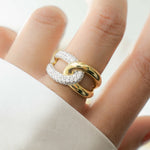 Model wearing gold two tone statement ring with criss cross ring design 