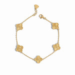 Close-up of a gold clover jewelry charm bracelet highlighting fine detailing.