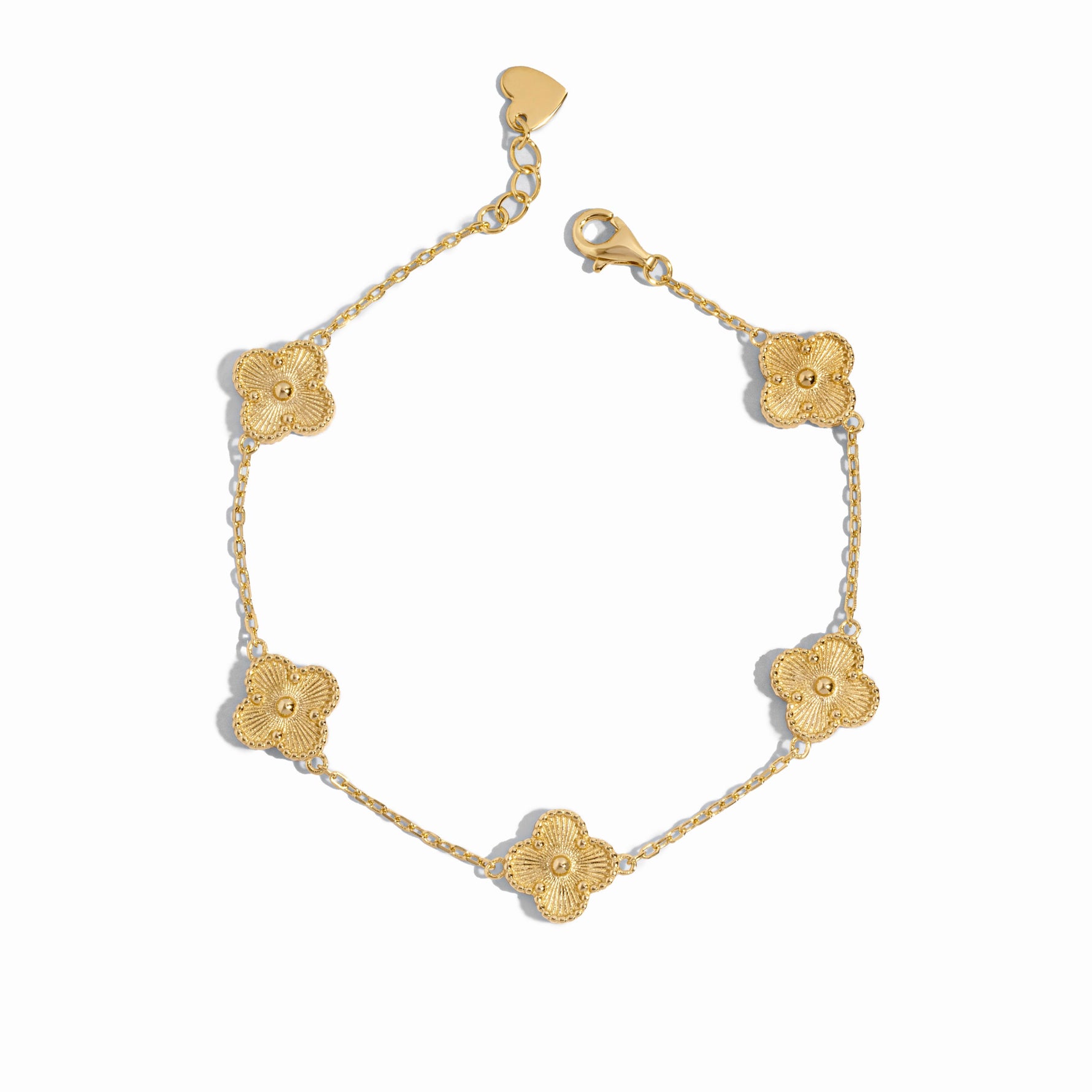 Close-up of a gold clover jewelry charm bracelet highlighting fine detailing.
