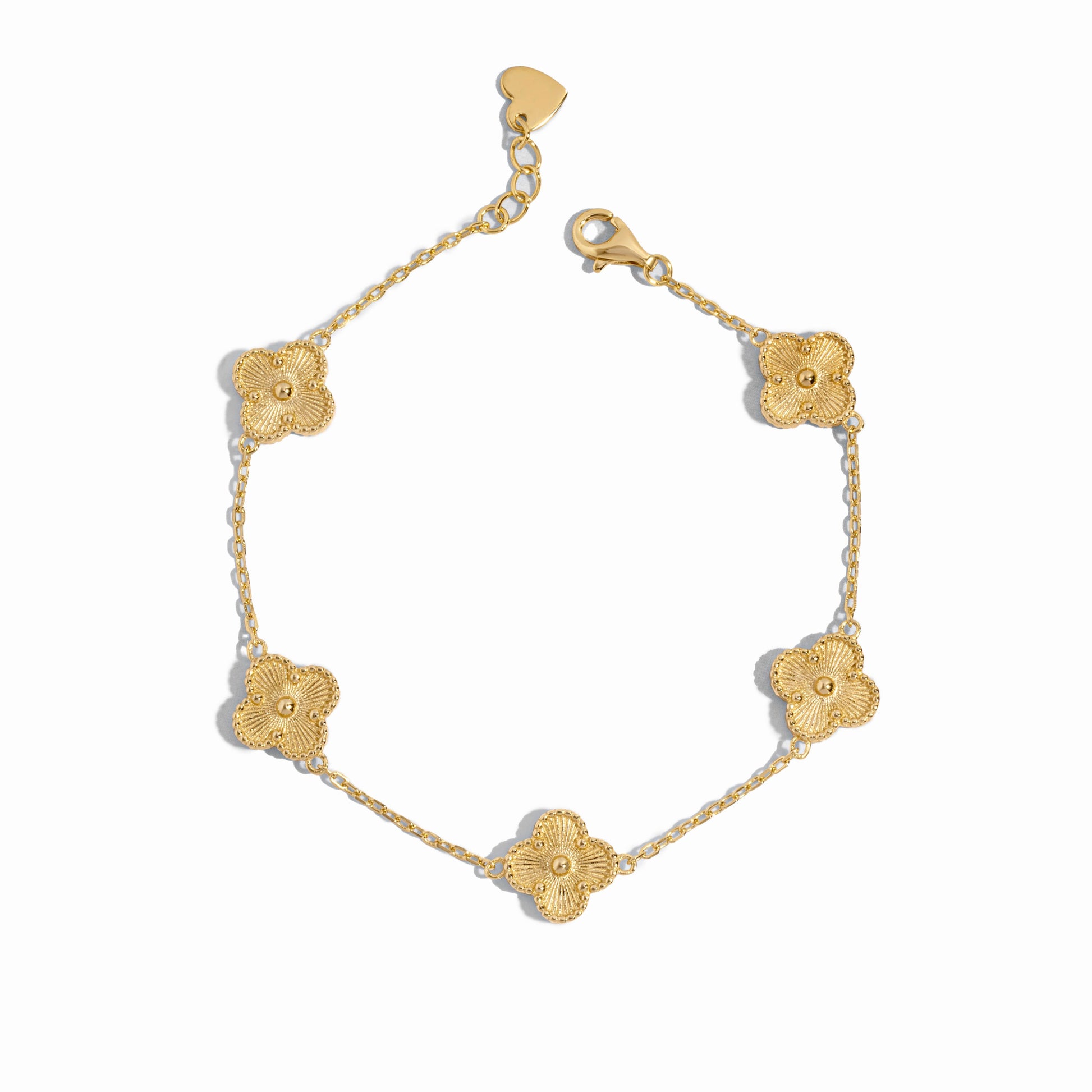Close-up of a gold clover jewelry charm bracelet highlighting fine detailing.