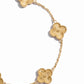 closeup image of four leaf clover design on gold chain bracelet