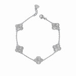 close up of silver charm bracelet of 5 four leaf clover charms