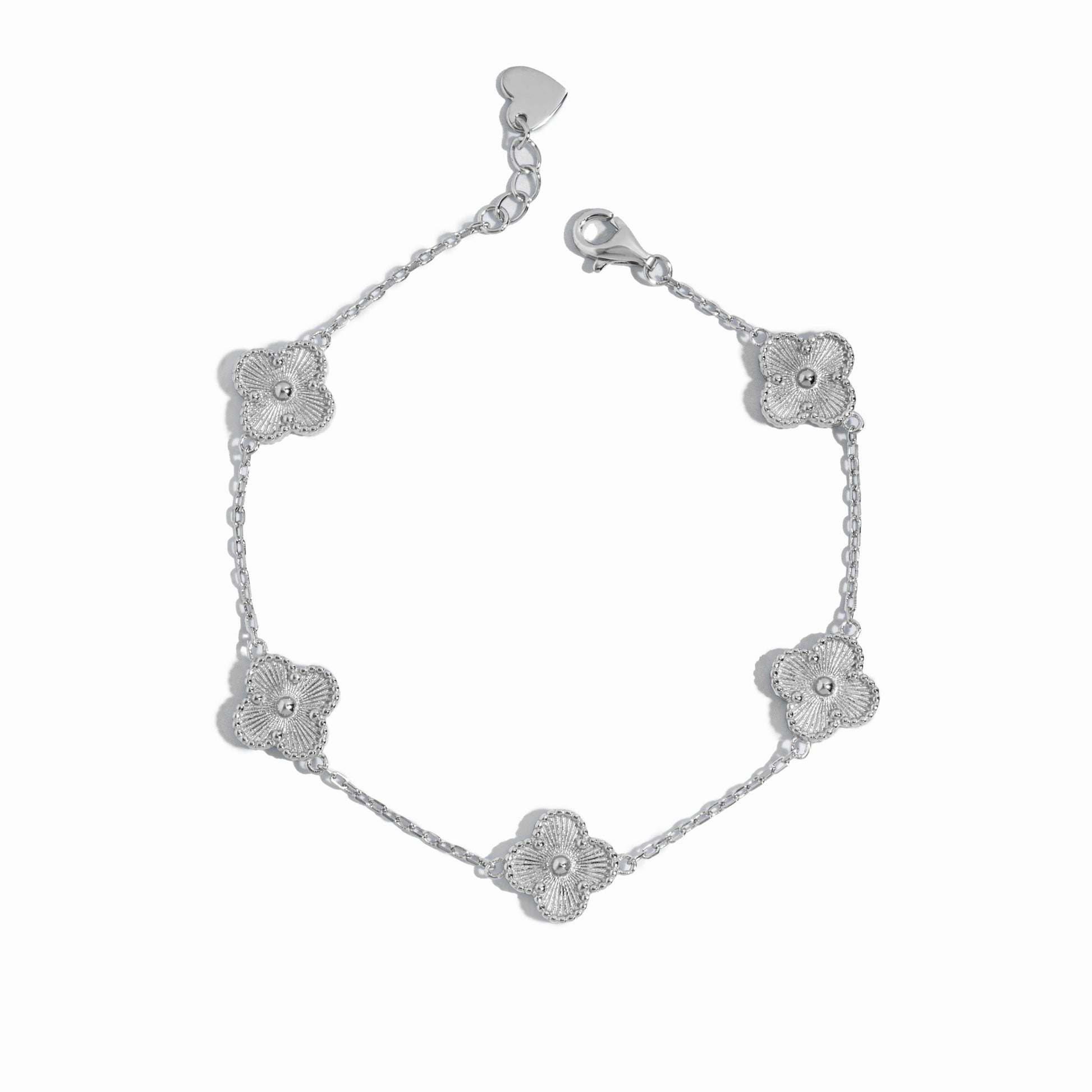 close up of silver charm bracelet of 5 four leaf clover charms