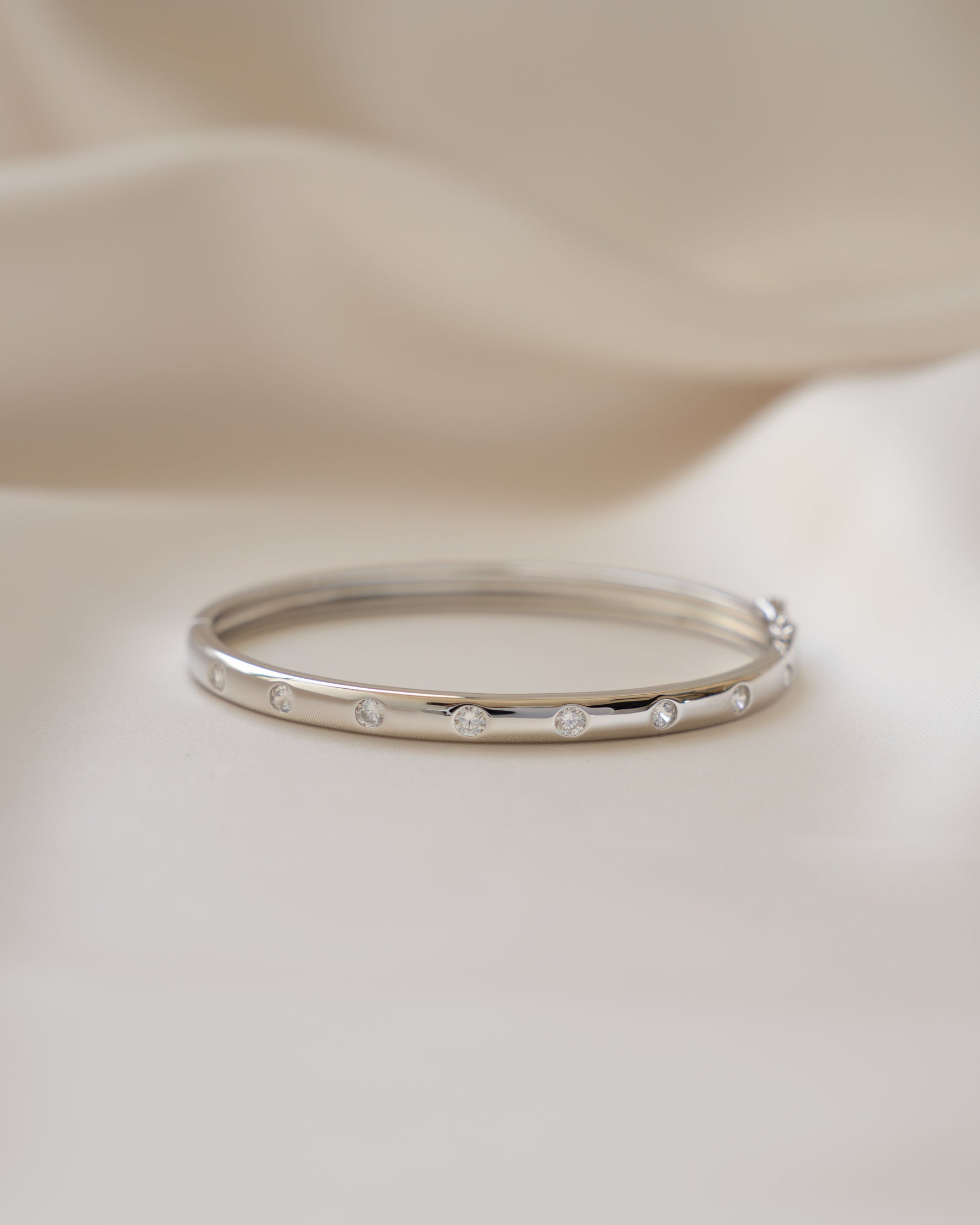 Sterling silver bridal jewelry featuring a silver bangle, with cubic zirconia diamonds