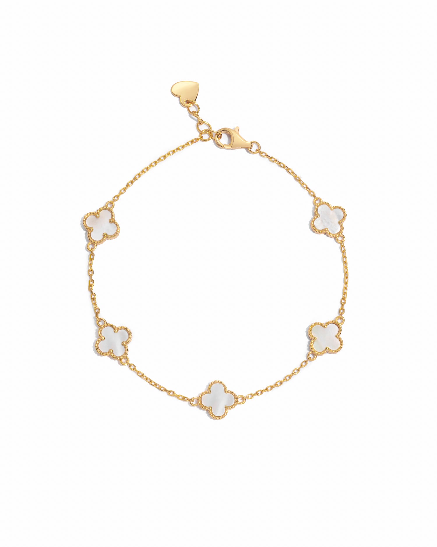 closeup image of a gold, mother of pearl four leaf clover charm bracelet against a white background