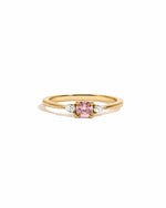 Gold ring with a pink cushion gemstone and smaller cz diamonds on a white background