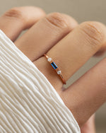 Sami Jewels sapphire baguette ring in rose gold, featuring a polished sapphire gemstone set in an elegant ring design.