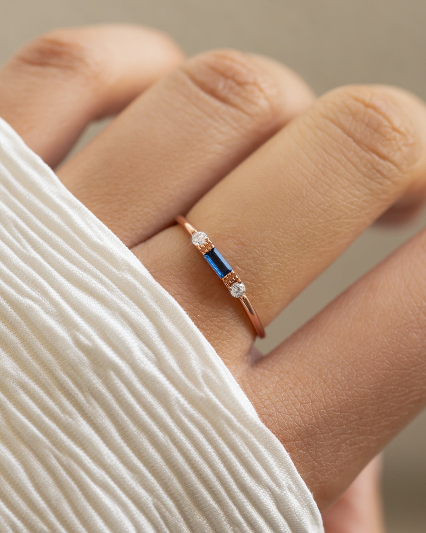 Sami Jewels sapphire baguette ring in rose gold, featuring a polished sapphire gemstone set in an elegant ring design.