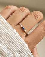 Sterling silver sapphire baguette ring by Sami Jewels featuring a rectangular blue sapphire gemstone.