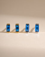 Sapphire baguette stud earrings by Sami Jewels featuring gold and sterling silver setting with rectangular sapphires.