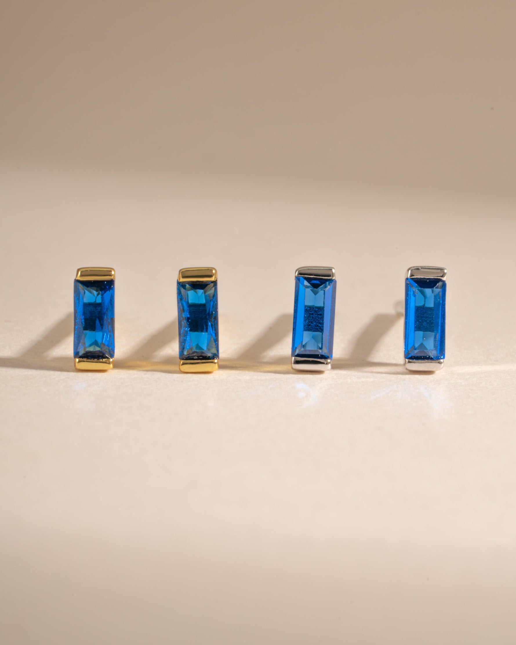 Sapphire baguette stud earrings by Sami Jewels featuring gold and sterling silver setting with rectangular sapphires.