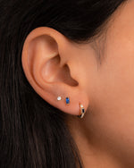 Gold sapphire baguette stud earrings by Sami Jewels featuring rectangular-cut blue sapphires set in classic gold settings.