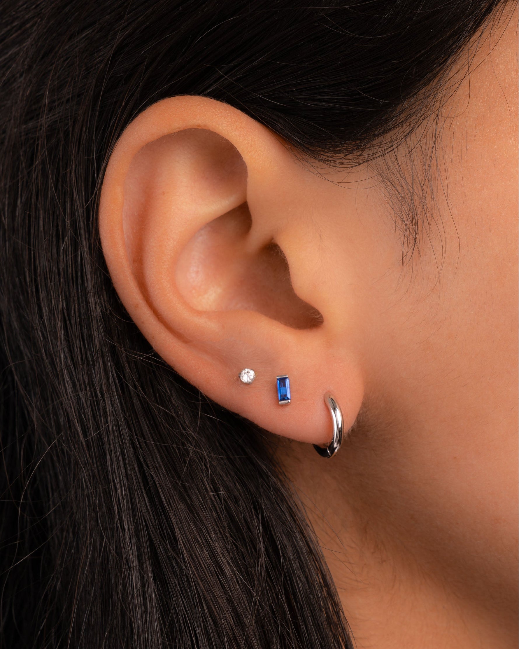 Sapphire baguette stud earrings by Sami Jewels featuring sterling silver settings and sparkling blue sapphires.