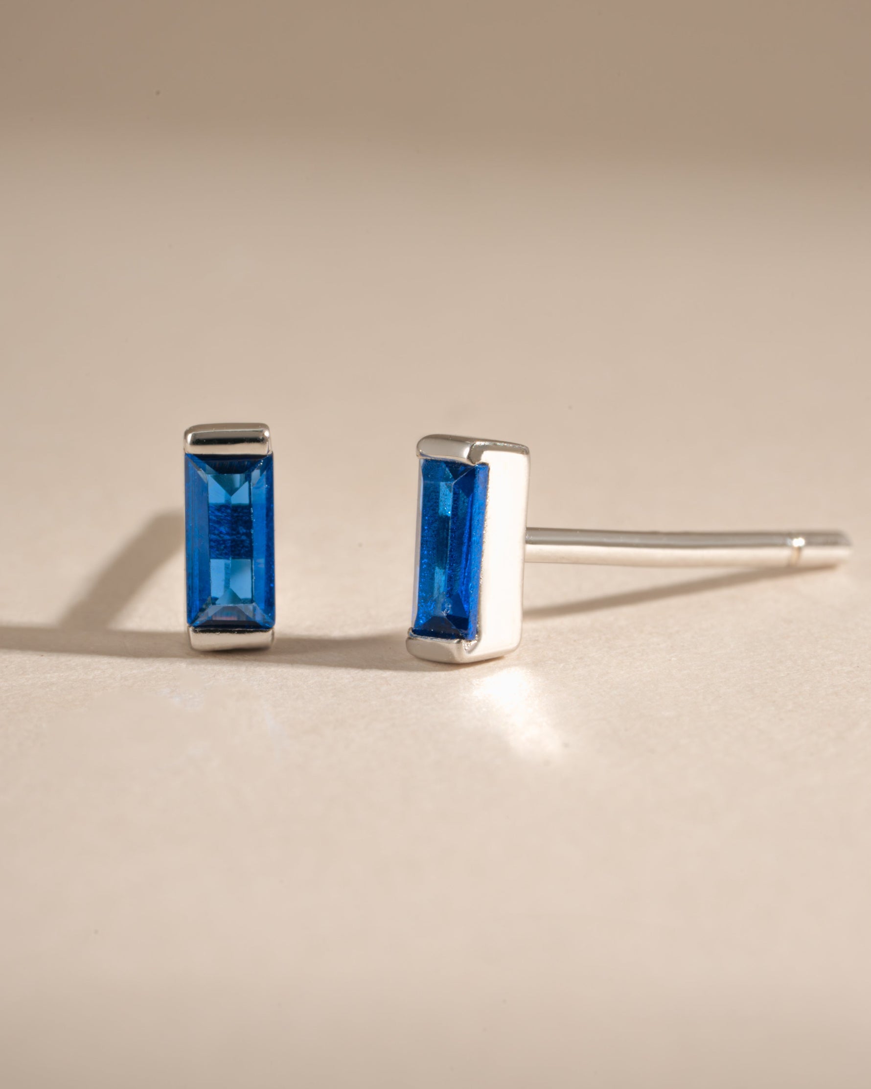 Sterling silver sapphire baguette stud earrings featuring rectangular-cut blue sapphires set in a sleek, elegant design.