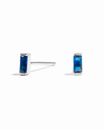Sami Jewels sapphire baguette stud earrings with sterling silver setting on a white background.