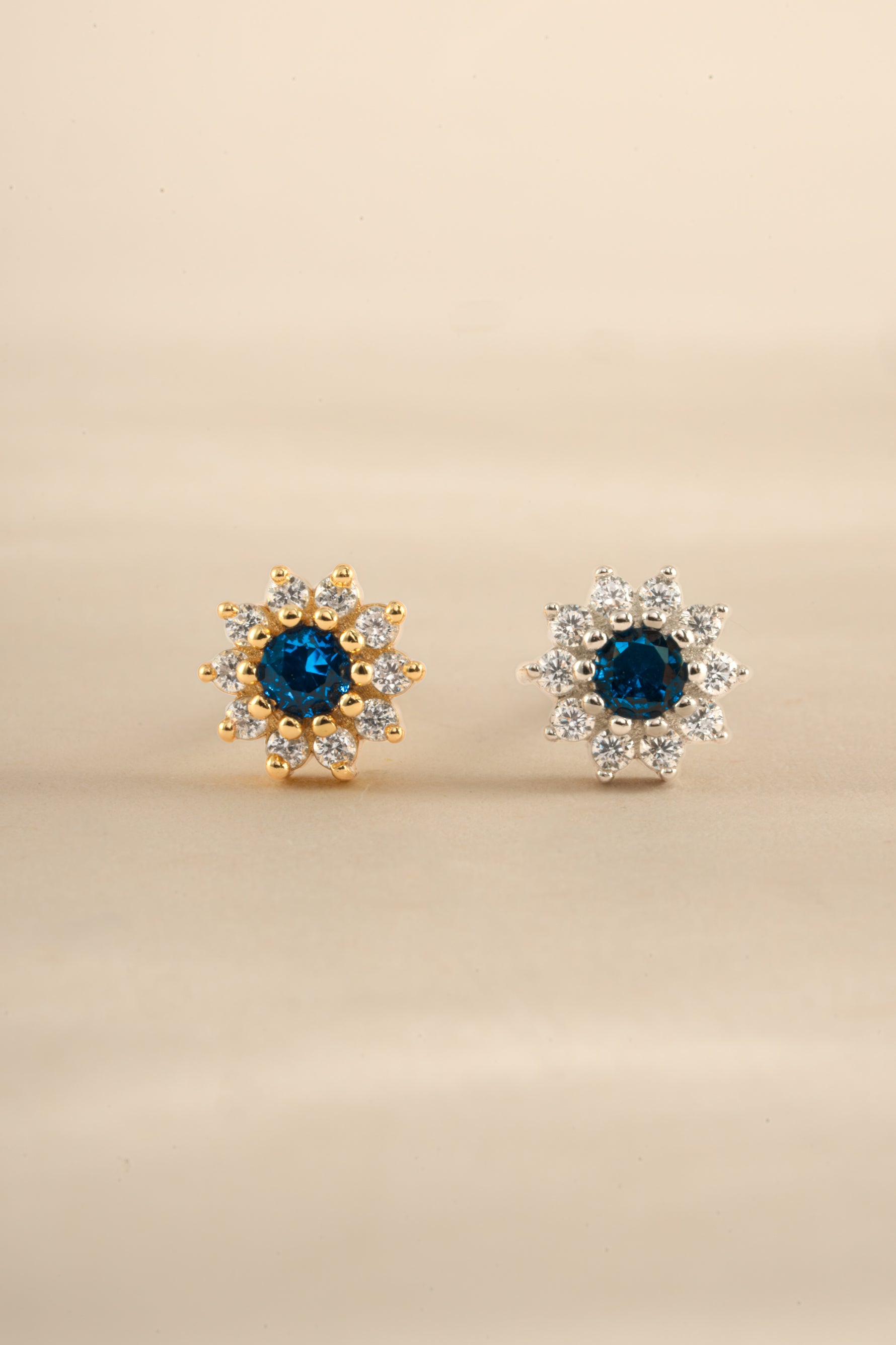 Sapphire dainty flower stud earrings by Sami Jewels featuring gold and sterling silver settings with floral design.