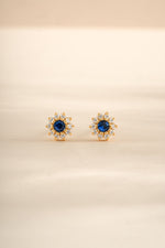 Gold sapphire dainty flower stud earrings by Sami Jewels featuring small, elegant gemstone floral design.
