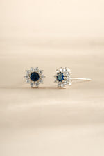 Sami Jewels sapphire dainty flower stud earrings in sterling silver, featuring delicate floral design and vibrant blue sapphires.