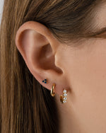 Sami Jewels Tiny Sapphire 3 Stone Stud Earrings featuring three sparkling blue sapphires on gold settings.