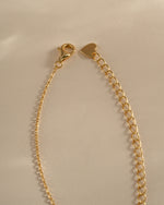 Gold sapphire evil eye necklace by Sami Jewels featuring a delicate chain and lobster clasp closure.